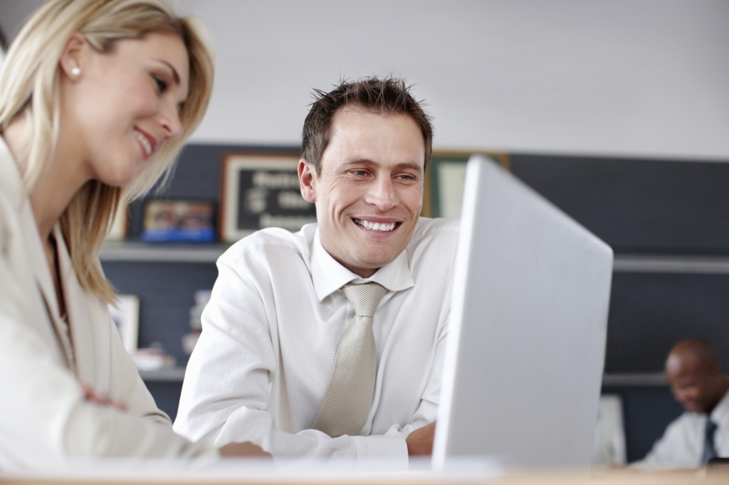 Two people looking at a laptop